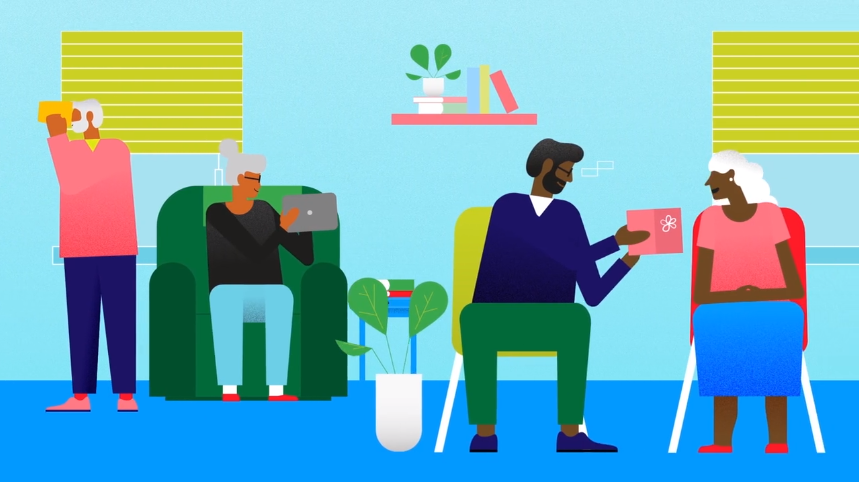 Younger people assist elderly with technology and conversation in a bright, friendly room.