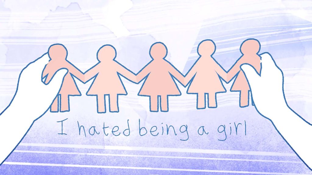 Hands hold a paper chain of girls over text reading “I hated being a girl” on a pastel background.