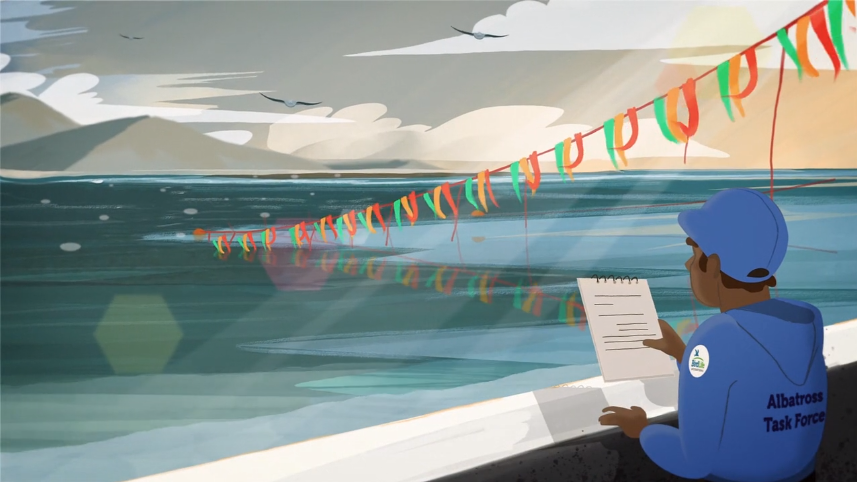 A conservationist on a boat takes notes while colourful streamers float above the ocean to deter seabirds.
