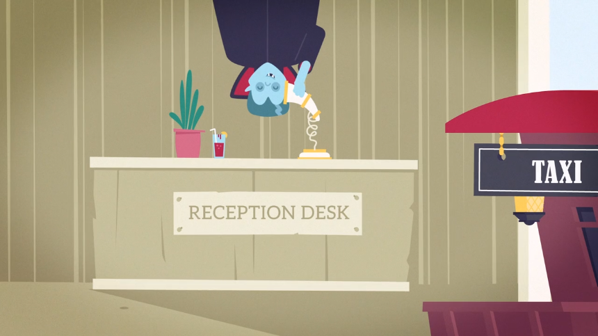 A vampire hangs upside down behind a reception desk while answering a phone in a quirky hotel lobby.